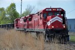 Northbound ballast train comes across the diamond